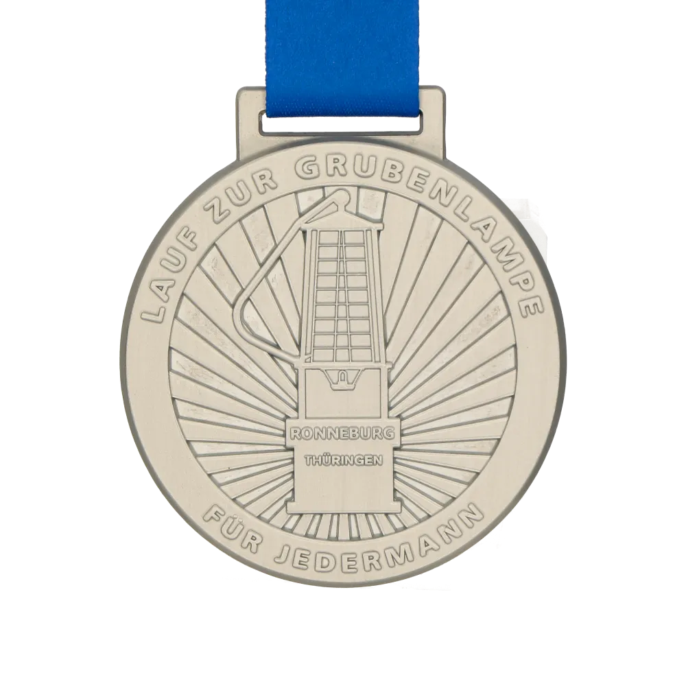 Silver medal with a lamp on a blue ribbon