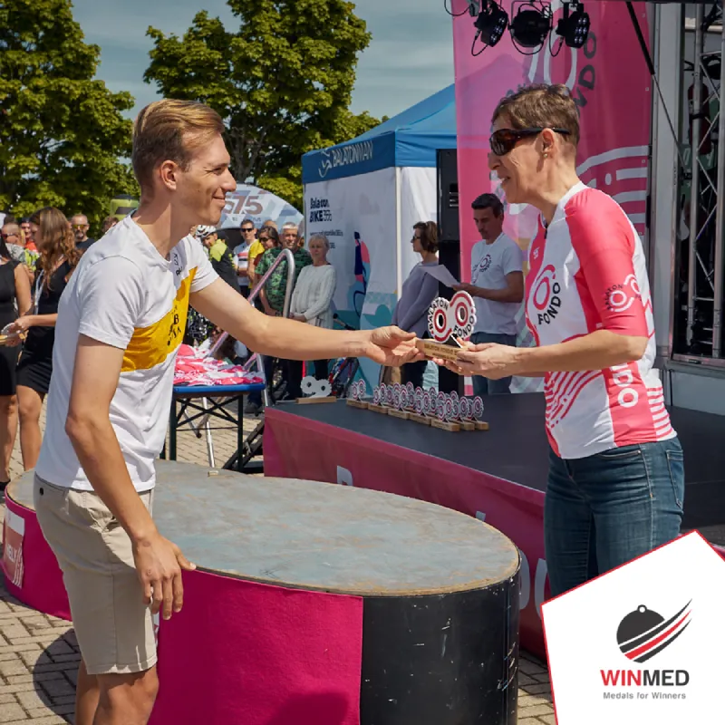 Awarding a cycling trophy to a cyclist for participating in a race