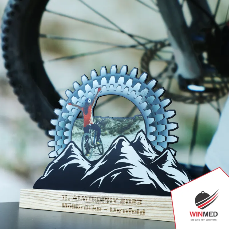 A metal cycling trophy on a wooden base