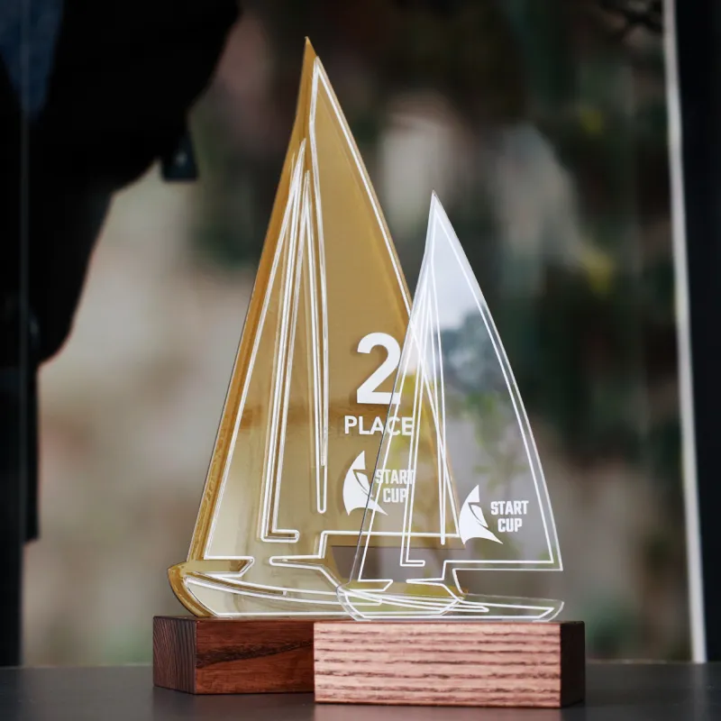 Two sailboat-shaped trophies